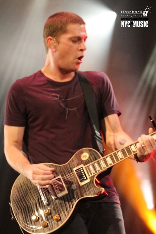 Rob Thomas, the lead singer of Matchbox Twenty plays the guitar on stage during a show.
